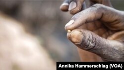 Meta Ba holds up a piece of gold in Senegal's Kedougou region Nov. 16, 2022. 