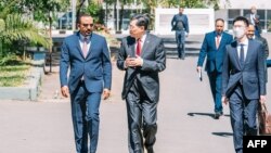 This handout image taken and distributed on Jan. 10, 2023, by the Ethiopian Prime Minister's Office in Addis Ababa shows Chinese Foreign Minister Qin Gang (2nd L) walking with Ethiopian Prime Minister Abiy Ahmed (L) during their bilateral meeting at the Prime Minister's office.