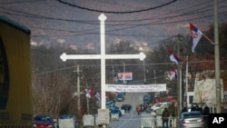 Serb protesters stand at the barricade near the village of Rudare, close to Zvecan, near the northern, Serb-dominated part of ethnically divided town of Mitrovica, Kosovo, Dec. 29, 2022.