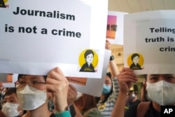 FILE - Press freedom advocates rally outside a court in Hong Kong, April 22, 2021.