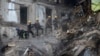 Ukrainian State Emergency Service firefighters clear the rubble at a building that was destroyed by a Russian attack in Kryvyi Rih, Ukraine, Dec. 16, 2022.