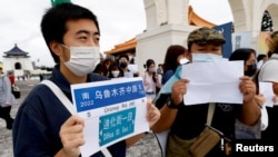 Taipei residents gather at the capital's Liberty Square in support of China's lockdown protests, in Taipei, Taiwan, Dec. 4, 2022. 