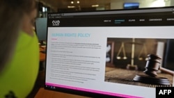 FILE - A woman checks the website of Israel-made Pegasus spyware at an office in the Cypriot capital Nicosia, July 21, 2021. 