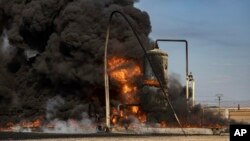 A smoke rises from an oil depot struck by Turkish air force near the town of Qamishli, Syria, Nov. 23, 2022. Turkish President Recep Tayyip Erdogan said he will carry out a land invasion into Kurdish areas of northern Syria.