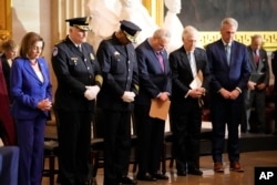 From left, Speaker of the House Nancy Pelosi of Calif., U.S. Capitol Police Chief J. Thomas Manger, Washington D.C. Metropolitan Police Chief Robert J. Contee, Senate Minority Leader Mitch McConnell of Ky., and House Minority Leader Kevin McCarthy of Calif., pray during a Congressional Gold Medal ceremony honoring law enforcement officers who defended the U.S. Capitol on Jan. 6, 2021, in the U.S. Capitol Rotunda in Washington, Tuesday, Dec. 6, 2022.