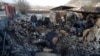 Local resident Mykola Kobzarenko inspects the remains of his garage destroyed during a Russian drone strike in the village of Stari Bezradychi, in Kyiv region, Dec. 19, 2022. 