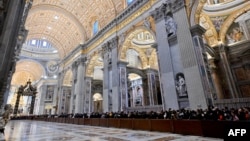 Faithful queue up to pay respect at the body of Pope Emeritus Benedict XVI at St. Peter's Basilica in the Vatican, Jan. 2, 2023. 