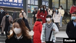 People walk out of a subway station during morning rush hour in Wuchang district, after the government gradually loosened restrictions on coronavirus disease (COVID-19) control, in Wuhan, Hubei province, China, Dec. 9, 2022. 