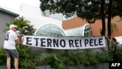 Fans of Brazilian football legend Pele hang a banner reading "Eternal King Pele," in Sao Paulo, Brazil, Dec. 29, 2022.