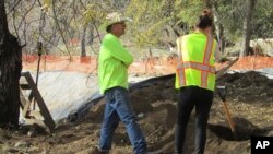 In this photo provided by Shawna Garcia, monitors working with the Wintu Tribe of Northern California search a construction site on Nov. 30, 2022, in Redding, California.