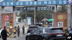 A convoy of vehicles, one of them carrying K-pop band BTS's member Jin arrive at an army training center in Yeoncheon, South Korea, Dec. 13, 2022. 