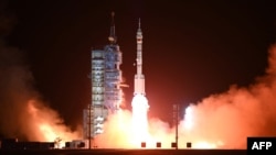 FILE - A Long March-2F carrier rocket, carrying the Shenzhou-15 spacecraft with three astronauts heading to China's Tiangong space station, lifts off from the Jiuquan Satellite Launch Center in Northwest China's Gansu Province, Nov. 29, 2022.
