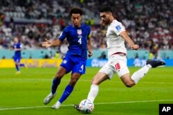 FILE- Iran's Ali Karimi play during the World Cup group B soccer match against the United States, in Doha, Qatar, Nov. 29, 2022.