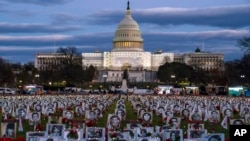 The US Capitol is seen behind a vigil honoring Iranians allegedly killed by their government during a rally in support of the ongoing protests in Iran at the National Mall in Washington, Dec. 17, 2022. 