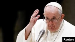 FILE - Pope Francis attends the weekly general audience at the Paul VI Hall at the Vatican, Dec. 14, 2022. 
