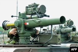 FILE - Taiwanese soldiers man mobile launchers of the U.S.-made TOW anti-tank missiles during a drill in Taoyuan county, April 18, 2012.