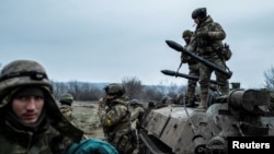 Servicemen of the Carpathian Sich Battalion are seen near an Armored Personnel Carrier (APC) on a frontline, as Russia's attack on Ukraine continues, near the town of Lyman, Donetsk region, Ukraine, Dec. 8, 2022.