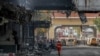 Rescuers gather in front of the Grand Diamond hotel-casino after a deadly fire broke out, in Poipet near the Thailand border, Cambodia.