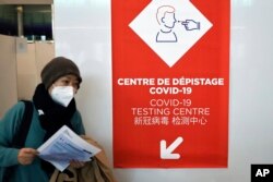 A passenger coming from China leaves a COVID-19 testing area set at the Roissy Charles de Gaulle airport, north of Paris, Jan. 1, 2023.