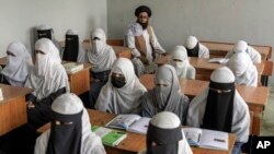 FILE - Afghan girls attend a religious school, which remained open since the last year's Taliban takeover, in Kabul, Afghanistan, Aug 11, 2022. (AP Photo/Ebrahim Noroozi, File)
