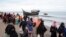 Ethnic Rohingya people walk to a temporary shelter after they landed on their wooden boat in North Aceh, Indonesia, Nov. 16, 2022.