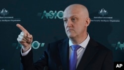 Australian Security Intelligence Organization director-general Mike Burgess points as he talks in Canberra, Australia, Monday, Nov. 28, 2022.