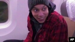 In this image made from video provided by Russian Federal Security Service, WNBA star and two-time Olympic gold medalist Brittney Griner sits in the plane as she flies to Abu Dhabi to be exchanged for Russian citizen Viktor Bout, in Russia, Dec. 9, 2022. 