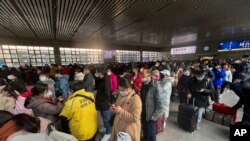 Travelers wearing masks at the West Railway Station in Beijing, Jan. 6, 2023. China is seeking to minimize the possibility of a major new COVID-19 outbreak during this month's Lunar New Year travel rush following the end of most pandemic containment measures. 
