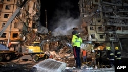 Rescuers work on a residential building destroyed in a Russian missile strike, in Dnipro, eastern Ukraine, Jan. 15, 2023, amid Russia's invasion of its neighbor. 