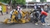 People inspect a damaged tricycle at the site of a bomb explosion, caused by a female suicide bomber in a market in Maiduguri, Nigeria, July 31, 2015. 