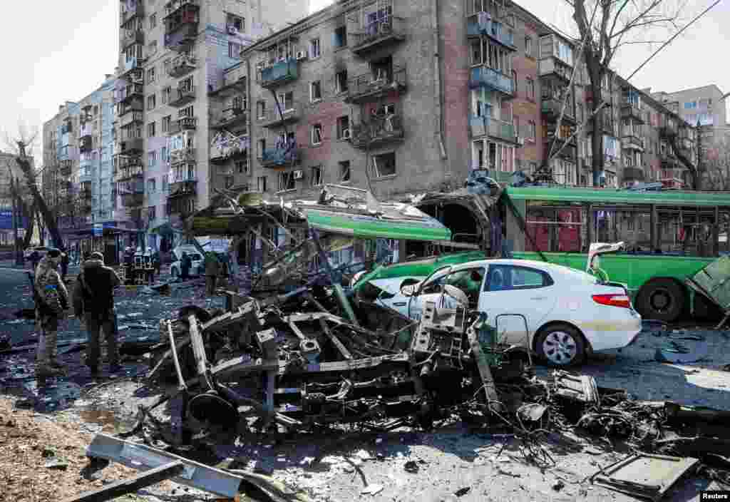 A building and vehicles are destroyed by Russian shelling in Kyiv, March 14, 2022.