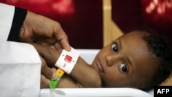 A nurse tends to a malnourished child at a treatment center in Yemen's western province of Hodeida on Feb. 15, 2022.
