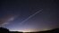 FILE - In this file photo taken Feb. 7, 2021, a long-exposure image shows a trail of a group of SpaceX's Starlink satellites passing over Uruguay as seen from the countryside some 185 kilometers north of Montevideo.