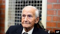 FILE - Leon Schwarzbaum poses for a photo in his home during an interview with the Associated Press in Berlin, Dec. 12, 2019. Schwarzbaum, holocaust survivor of the Nazis’ death camp at Auschwitz and lifelong fighter for justice for the victims of the Hol