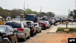 FILE - Motorists queue to buy fuel at a filling station following a fuel shortage and causing traffic gridlock in Lagos, Nigeria, on March 3, 2022.