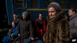 Ukrainians escaping from the besieged city of Mariupol along with other passengers from Zaporizhzhia arrive at Lviv, western Ukraine, March 20, 2022.