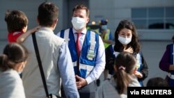 Afghan refugees are greeted after arriving in Canada on Aug. 4, 2021.