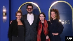 FILE - Best animated feature film nominees for "Flee" Jonas Poher Rasmussen, Monica Hellstrom, Signe Byrge Sorensen and Charlotte De La Gournerie arrives for the 94th Annual Oscars Nominees Luncheon in Los Angeles, March 7, 2022.