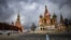 FILE - A woman walks near the Kremlin and St. Basil's Cathedral in central Moscow, Russia, Feb. 22, 2022. 