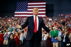 President Donald Trump arrives to speak to a campaign rally at the Ford Center, Aug. 30, 2018, in Evansville, Ind.