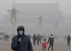 FILE - A man wears a mask on Tiananmen Square in thick haze in Beijing, Jan. 29, 2013.