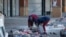 FILE - Two local women sort through debris following a looting at Diepkloof Square, Soweto, Johannesburg, July 14, 2021.