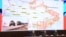 Russian officials hold a briefing on Russian military action in Ukraine, in Moscow on March 25, 2022. The screen shows the map of Ukraine.
