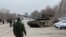 Service members of pro-Russian troops are seen atop of a tank on the outskirts of the besieged southern port city of Mariupol, Ukraine, March 20, 2022.