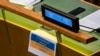 FILE - A sign reading "#TodayWeAreAllUKRAINE" hangs from the desk of the Swiss delegation, Feb. 28, 2022, at United Nations Headquarters.