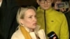 Marina Ovsyannikova, a Channel One employee who staged an on-air protest as she held up a anti-war sign behind a studio presenter, speaks to the media as the leaves the court building in Moscow, Russia March 15, 2022 in this still image taken from a video.