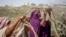 Somali women who fled drought-stricken areas start to build shelters at a makeshift camp on the outskirts of the capital Mogadishu, Somalia, Feb. 4, 2022.