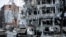 FILE - Damaged vehicles and buildings in Kharkiv city center in Ukraine, March 16, 2022. 