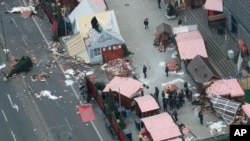 German Chancellor Angela Merkel and other government members visit the site of the attack in Berlin, Germany, Dec. 20, 2016, the day after a truck ran into a crowded Christmas market and killed several people. 