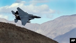 FILE - An F-15E Strike Eagle from Seymour Johnson AFB in North Carolina flies out of the nicknamed "Star Wars Canyon" turning toward the Panamint range over Death Valley National Park, California, Feb. 27, 2017.